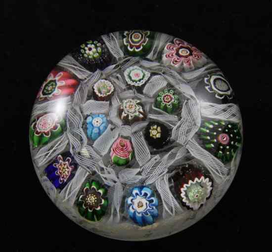 Appraisal: A Clichy millefiori and latticino glass paperweight with concentric design