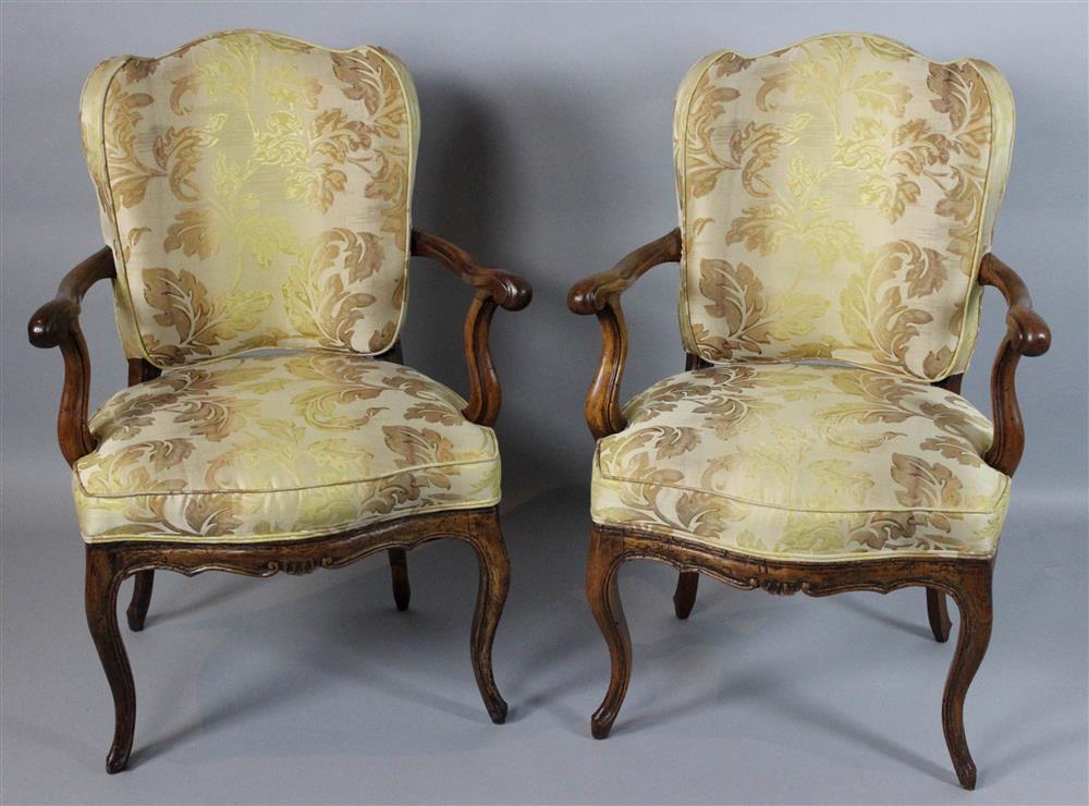 Appraisal: PAIR OF FRENCH PROVINCIAL WALNUT FAUTEUILS SOUTH OF FRANCE Cowtan