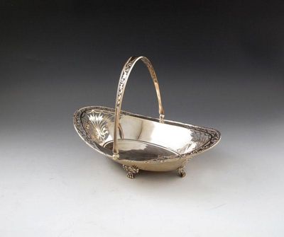 Appraisal: An Edwardian silver swing-handled basket by James Dixon and Sons