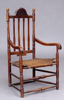 Appraisal: NEW ENGLAND MAPLE BANISTER BACK ARMCHAIR The shaped top rail