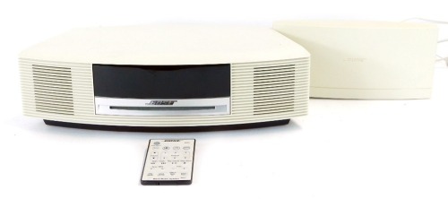 Appraisal: A Bose music wave system in cream with remote and