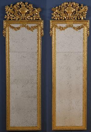 Appraisal: PAIR OF LOUIS XVI-STYLE CARVED GILTWOOD PIER MIRRORS Each antiqued