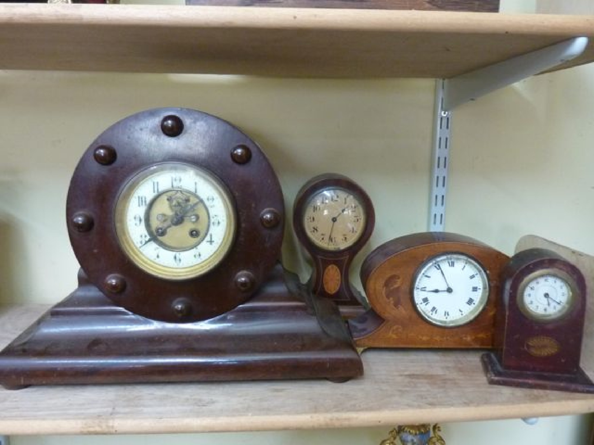 Appraisal: Four timber cased clocks including an example with simulated propellor