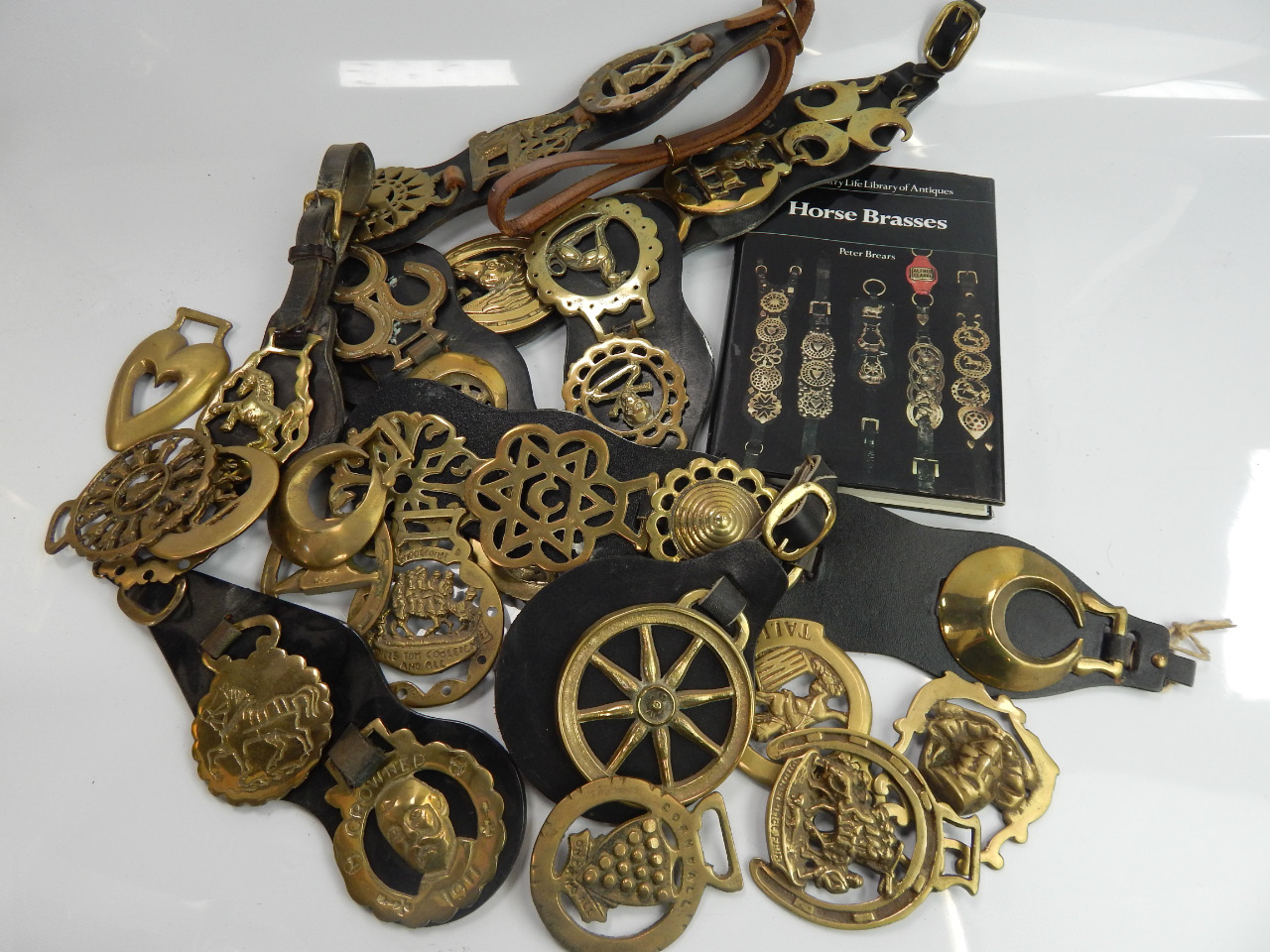 Appraisal: A collection of horse brasses and martingale straps together with