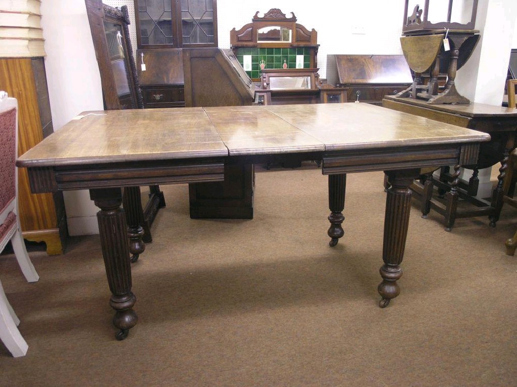 Appraisal: A Victorian walnut wind-action dining table on reeded and turned