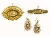 Appraisal: A VICTORIAN GOLD SHUTTLE SHAPED BROOCH with applied decoration a