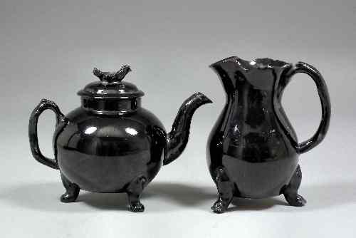 Appraisal: An th Century English black glazed Jackfield globular teapot and