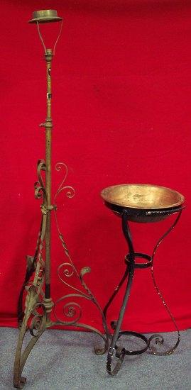 Appraisal: A wrought iron adjustable oil lamp stand on a scrolling