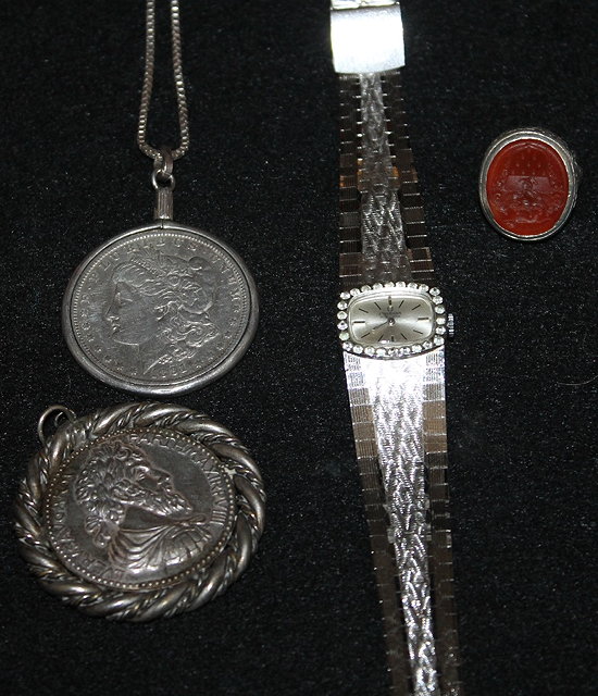 Appraisal: AN AMERICAN SILVER DOLLAR together with a medallion a ladies