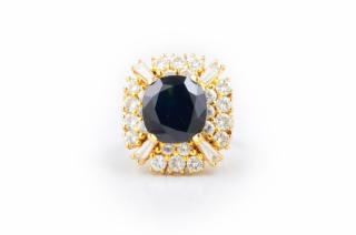 Appraisal: A Dark Sapphire and Diamond Cocktail Ring Centered with a