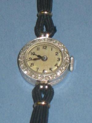 Appraisal: A DIAMOND COCKTAIL WATCH the silvered circular dial with diamond