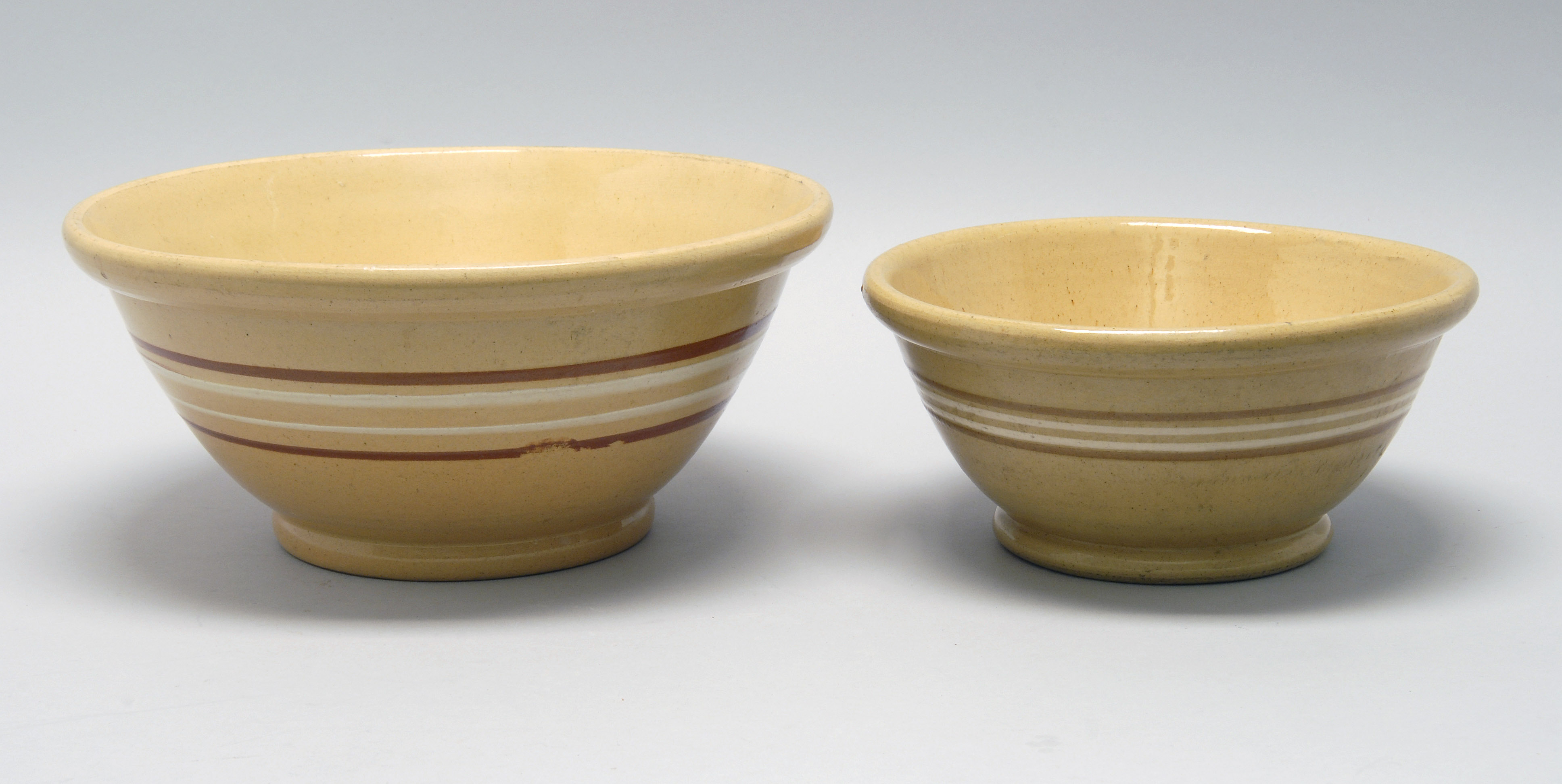 Appraisal: TWO EARLY TH CENTURY YELLOWWARE MIXING BOWLS with cream and