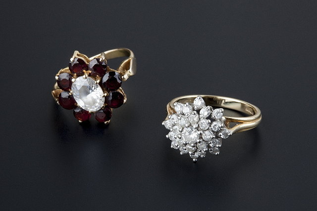 Appraisal: Two cluster rings comprising a tiered diamond cluster ring claw