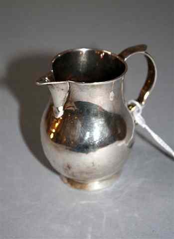 Appraisal: A GEORGE II SILVER CREAM JUG of baluster form double