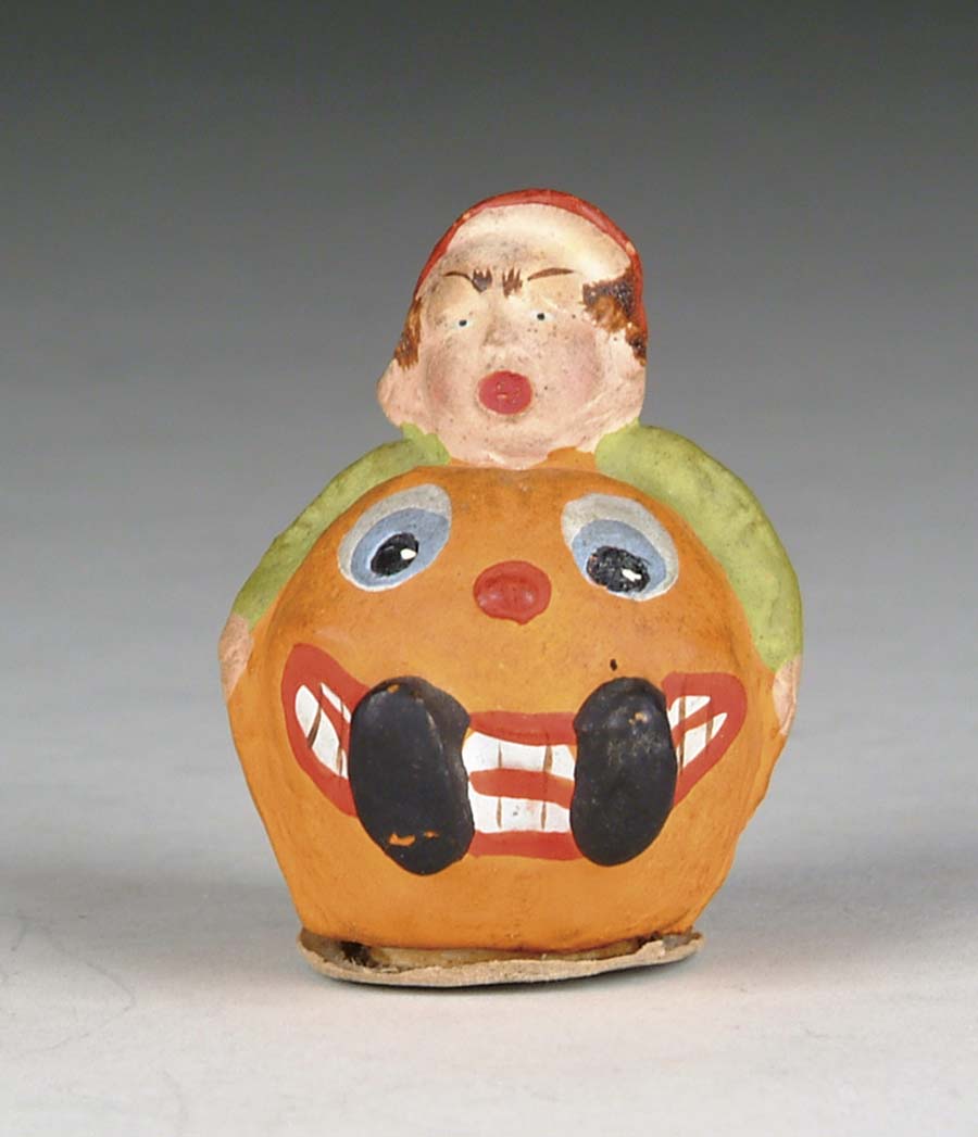 Appraisal: BOY IN PUMPKIN CANDY CONTAINER Composition figure of jack-o-lantern head