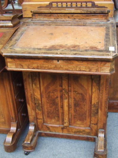 Appraisal: An inlaid Victorian walnut davenport the lift top super structure