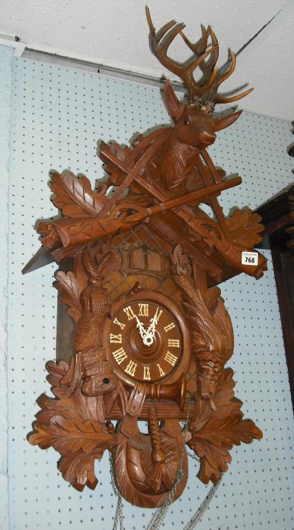 Appraisal: Contemporary Black Forest three train cuckoo clock the dial within