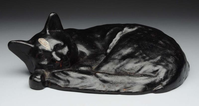 Appraisal: Cast Iron Lying Down Sleeping Cat Doorstop Realistic life size