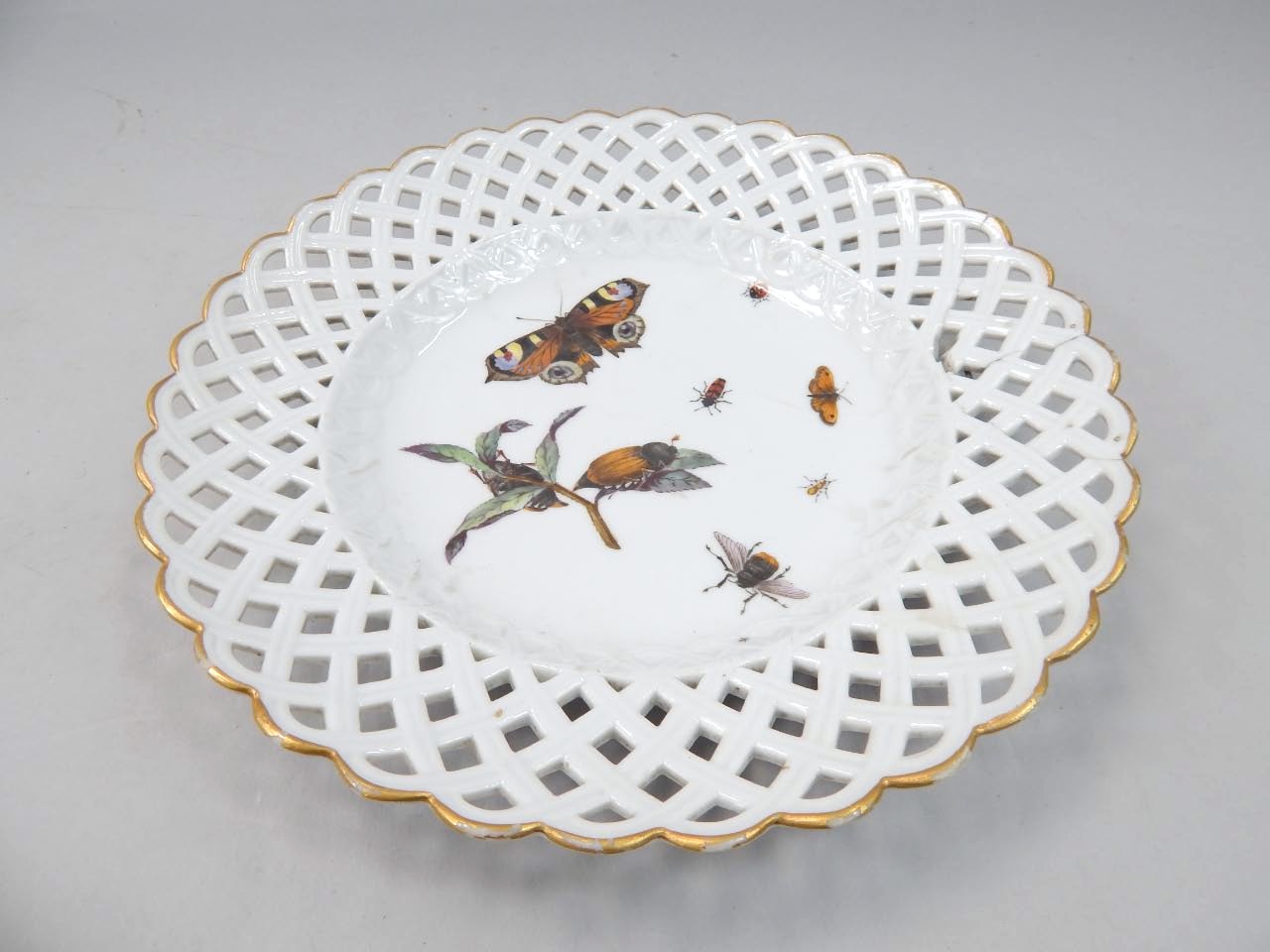 Appraisal: A Meissen Marcolini period ribbon plate painted centrally with butterflies