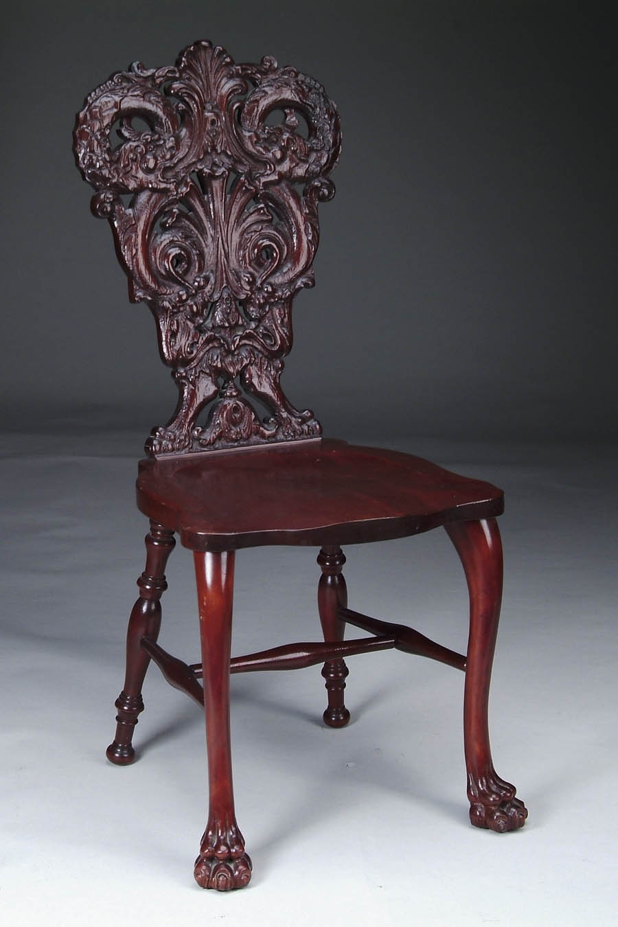 Appraisal: LAVISHLY CARVED MAHOGANY SIDE CHAIR Dragon carved back has leaf