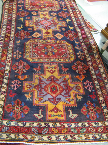 Appraisal: PERSIAN TRIBAL HALL CARPET the dark blue field decorated with