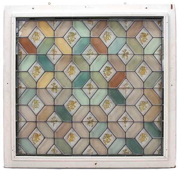 Appraisal: A polychrome decorated stained glass window together with a wrought