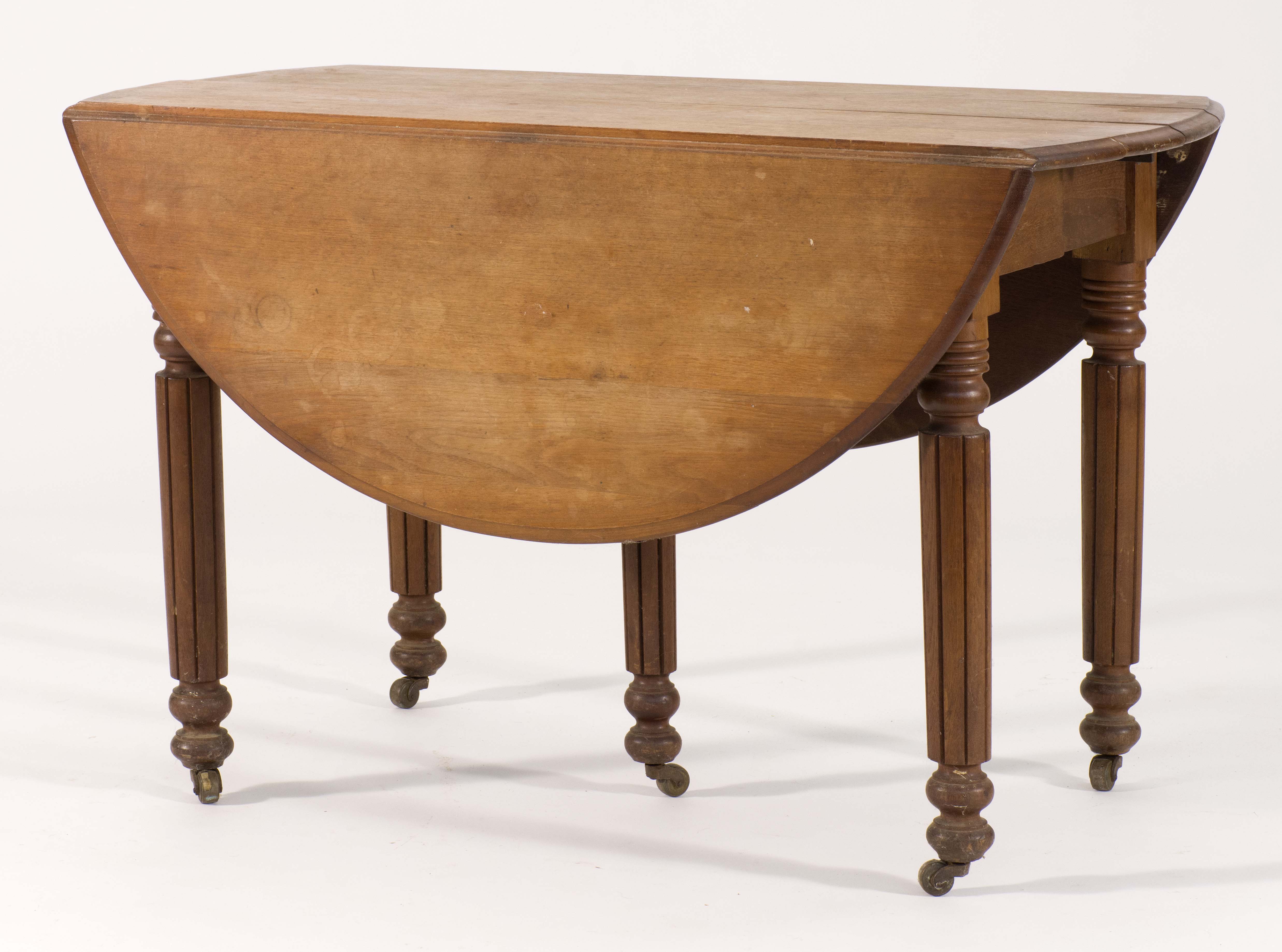 Appraisal: DROP-LEAF EXTENSION DINING TABLE Circa In walnut Turned and chamfered