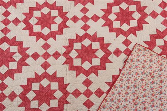 Appraisal: RED STAR VARIATION QUILT Red cotton stars worked on a