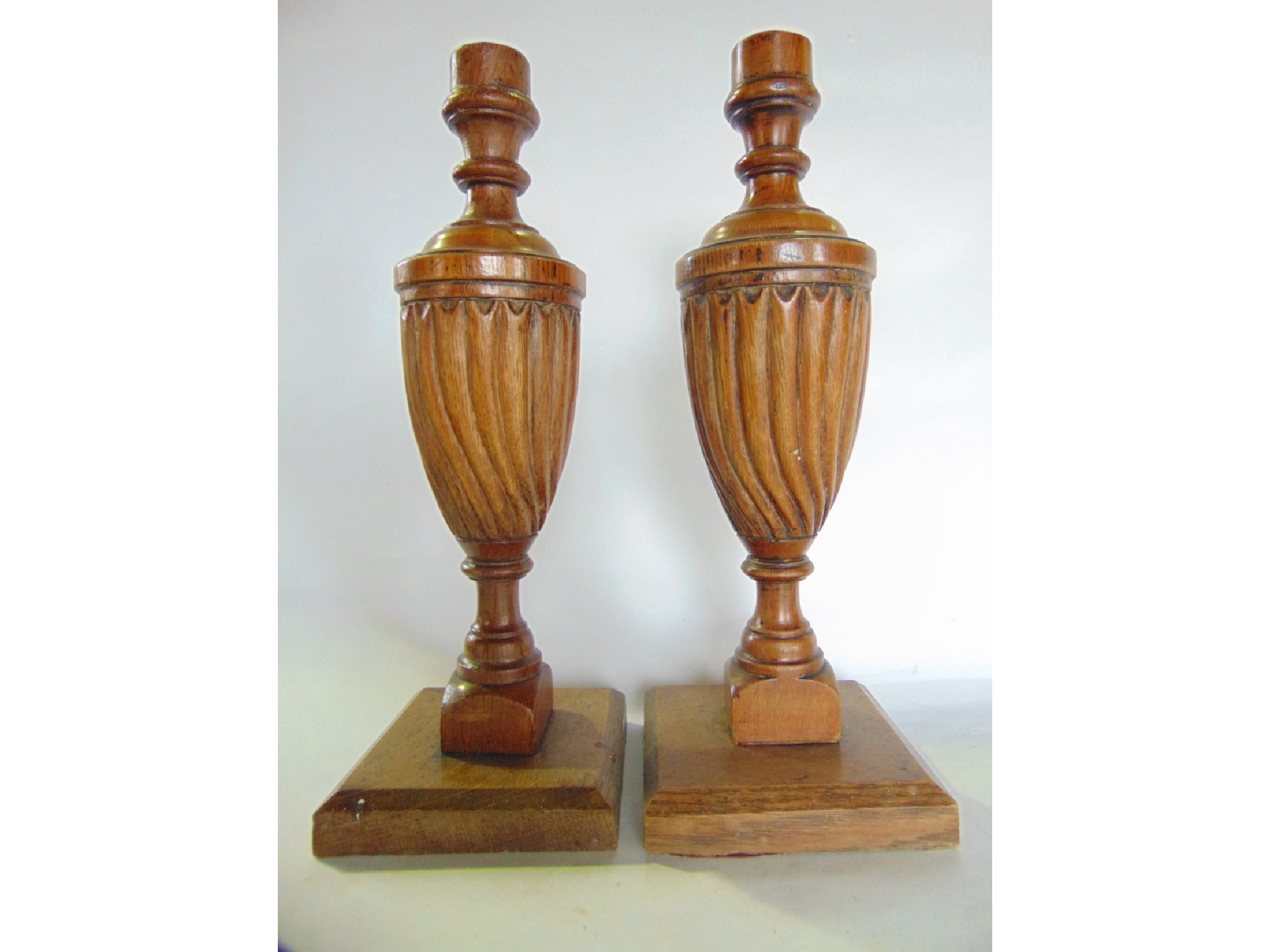 Appraisal: A pair of carved and turned oak candlesticks each of