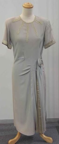 Appraisal: Dinner dress in grey crepe with rosette detail to the