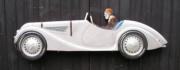 Appraisal: A hand-painted wooden profile of a BMW finished in silver