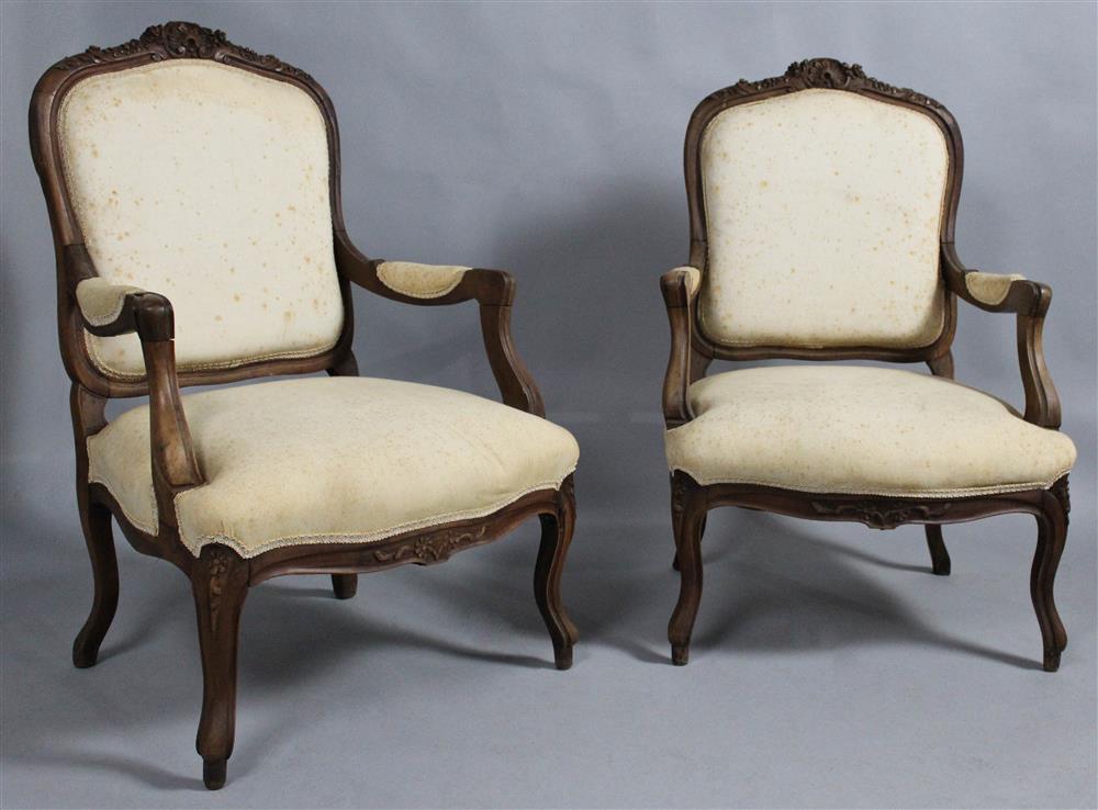 Appraisal: PAIR OF LOUIS XV STYLE CARVED WALNUT FAUTEUILS each with