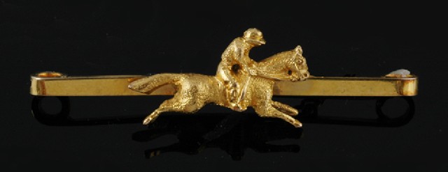 Appraisal: A gold bar brooch Centrally set with a horse and