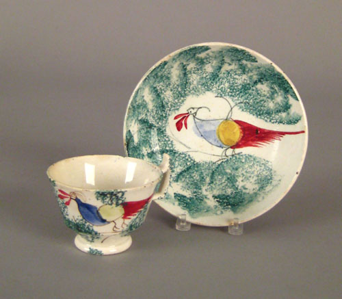 Appraisal: Child's teal spatter cup and saucer th c with peafowl