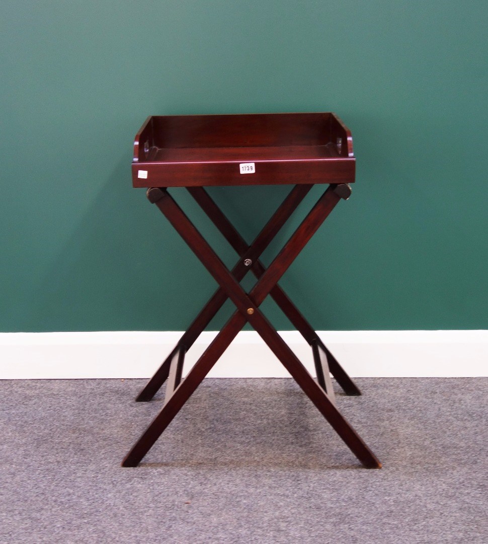 Appraisal: A small th century mahogany butler's tray on a folding