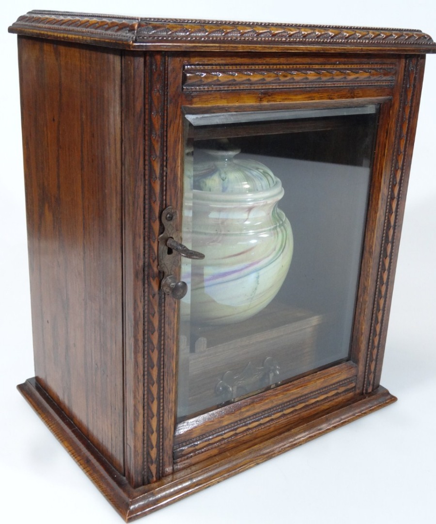 Appraisal: An Edwardian oak cased smokers cabinet with marble pottery jar