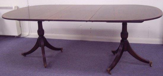 Appraisal: A twin pedestal dining table with additional pedestal to match