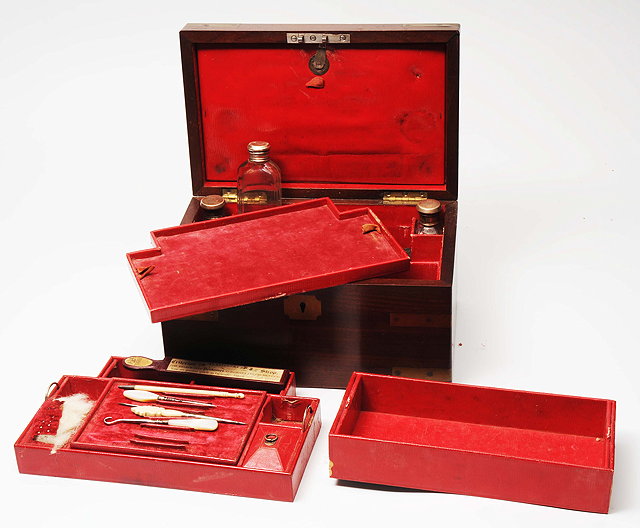 Appraisal: A MAHOGANY BRASS BOUND TRAVELLING VANITY SET fitted with silver