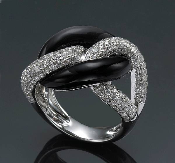 Appraisal: A diamond and black onyx ring estimated total diamond weight