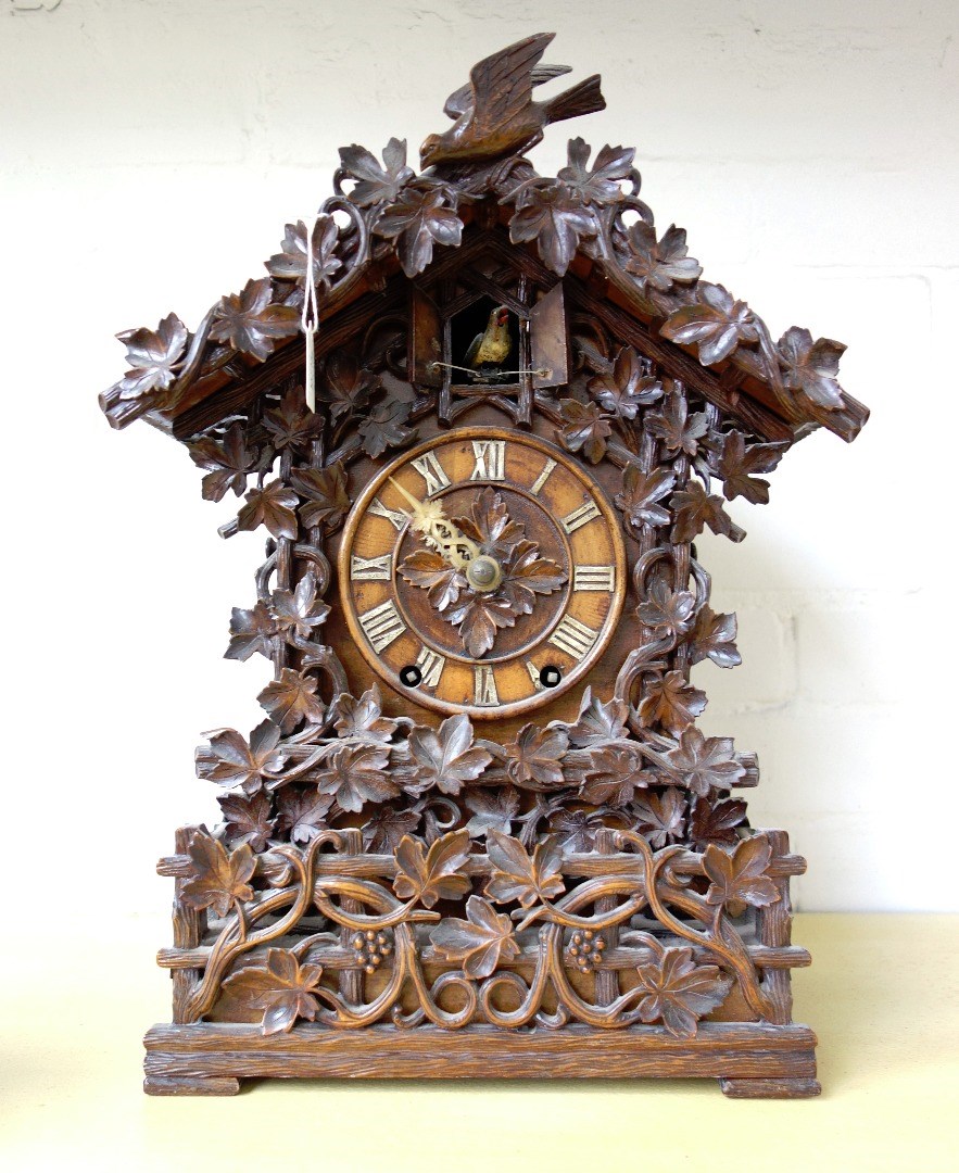 Appraisal: A Black Forest carved walnut or Linden wood mantel clock