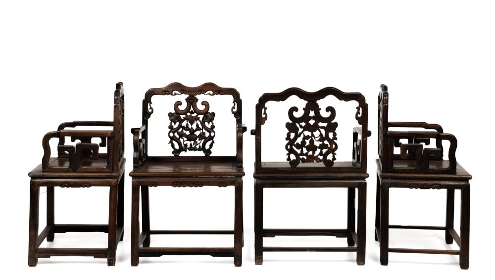 Appraisal: Four Chinese carved wood armchairs First-quarter th Century Each with