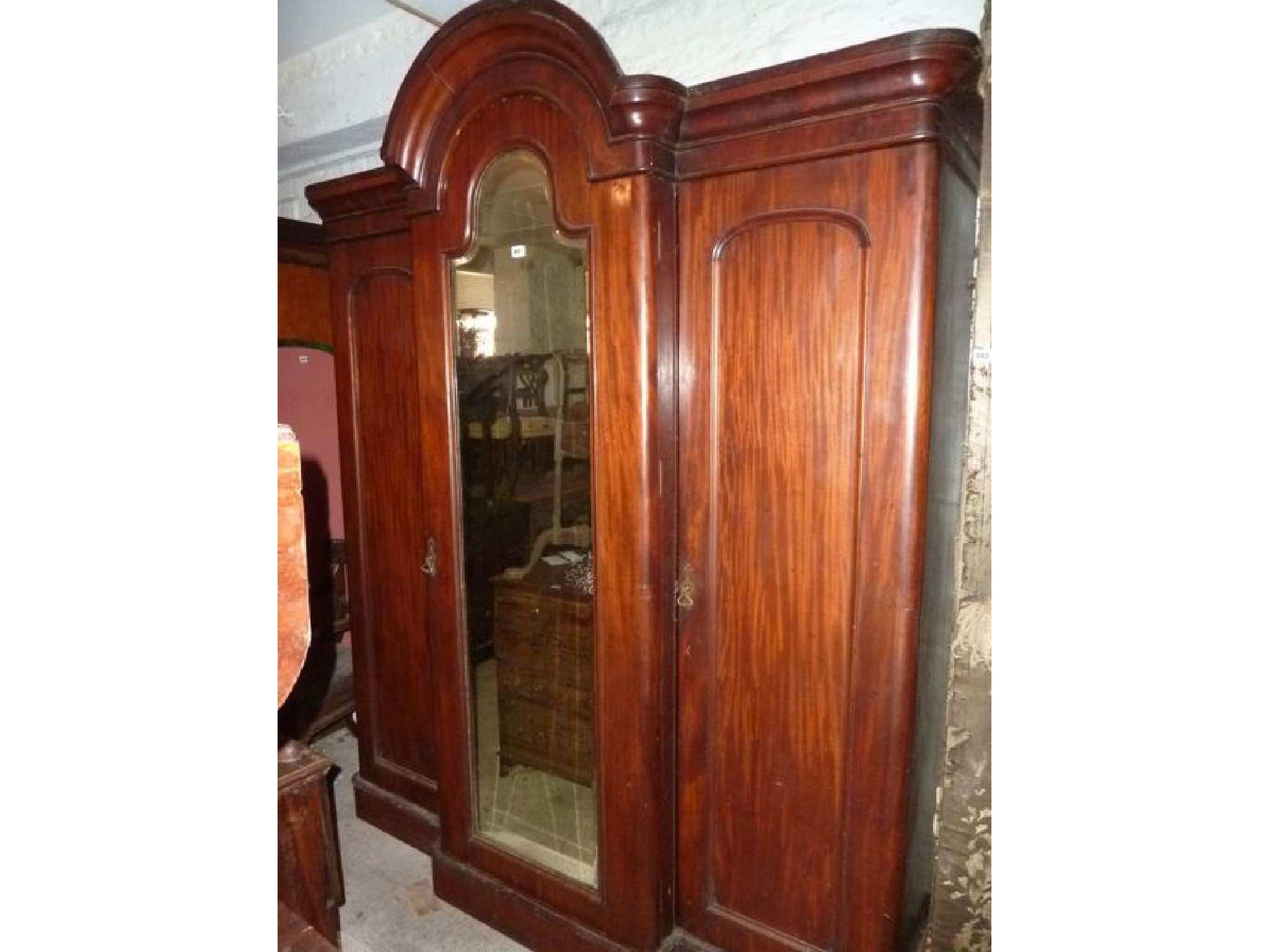 Appraisal: A Victorian mahogany triple wardrobe the central breakfront enclosed by