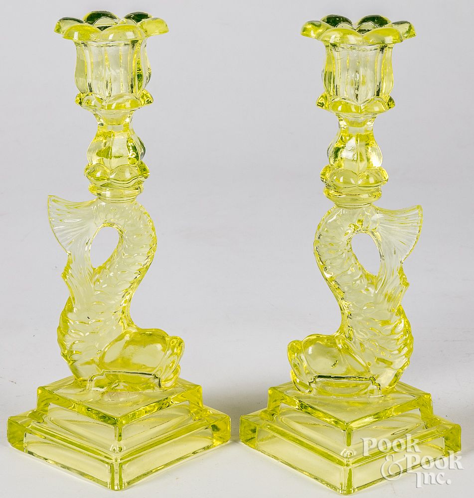 Appraisal: Pair of vaseline glass dolphin candlesticks Pair of vaseline glass