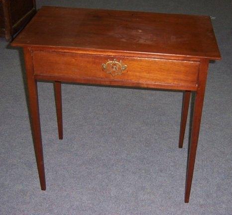 Appraisal: A walnut table with plain rectangular top fitted a drawer