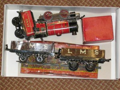 Appraisal: A playworn Hornby red clockwork M locomotive two coal trucks