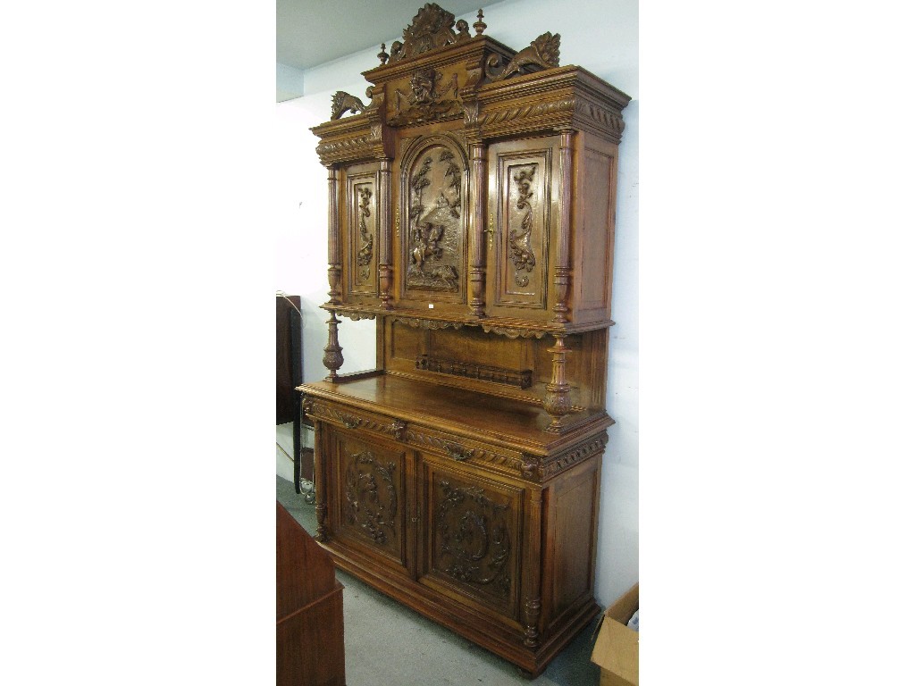 Appraisal: Large continental carved walnut cabinet on cupboard base the upper