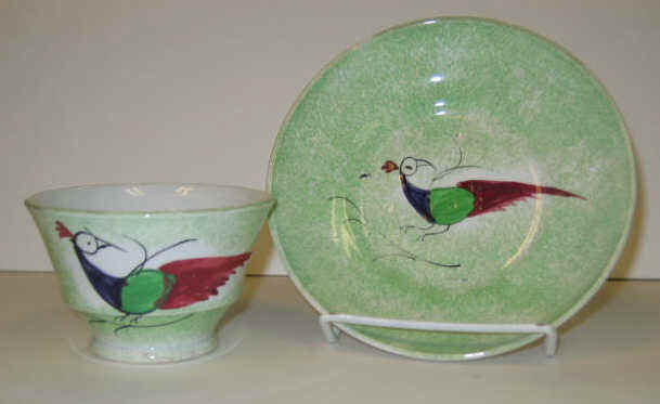 Appraisal: ENGLISH SPATTERWARE Green spatter Peafowl handless cup and saucer decorated