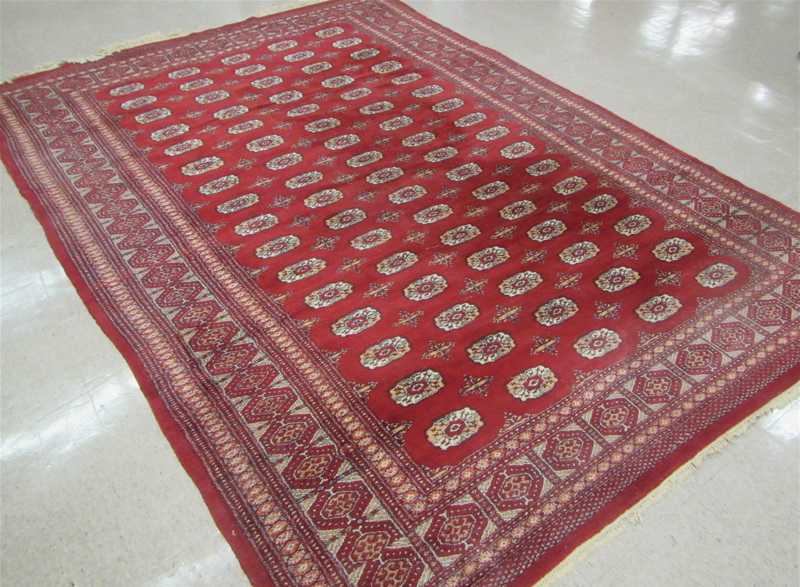 Appraisal: HAND KNOTTED ORIENTAL CARPET Indo-Bokhara Turkoman gol design on red