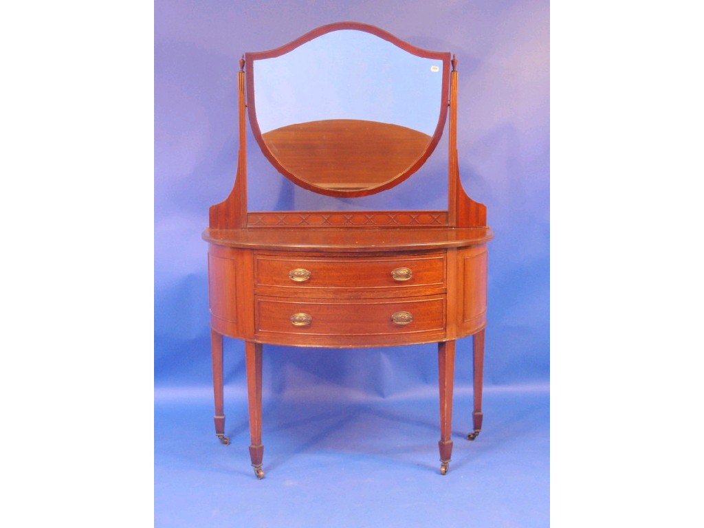 Appraisal: An Edwardian mahogany dressing table of demi-lune form with shield