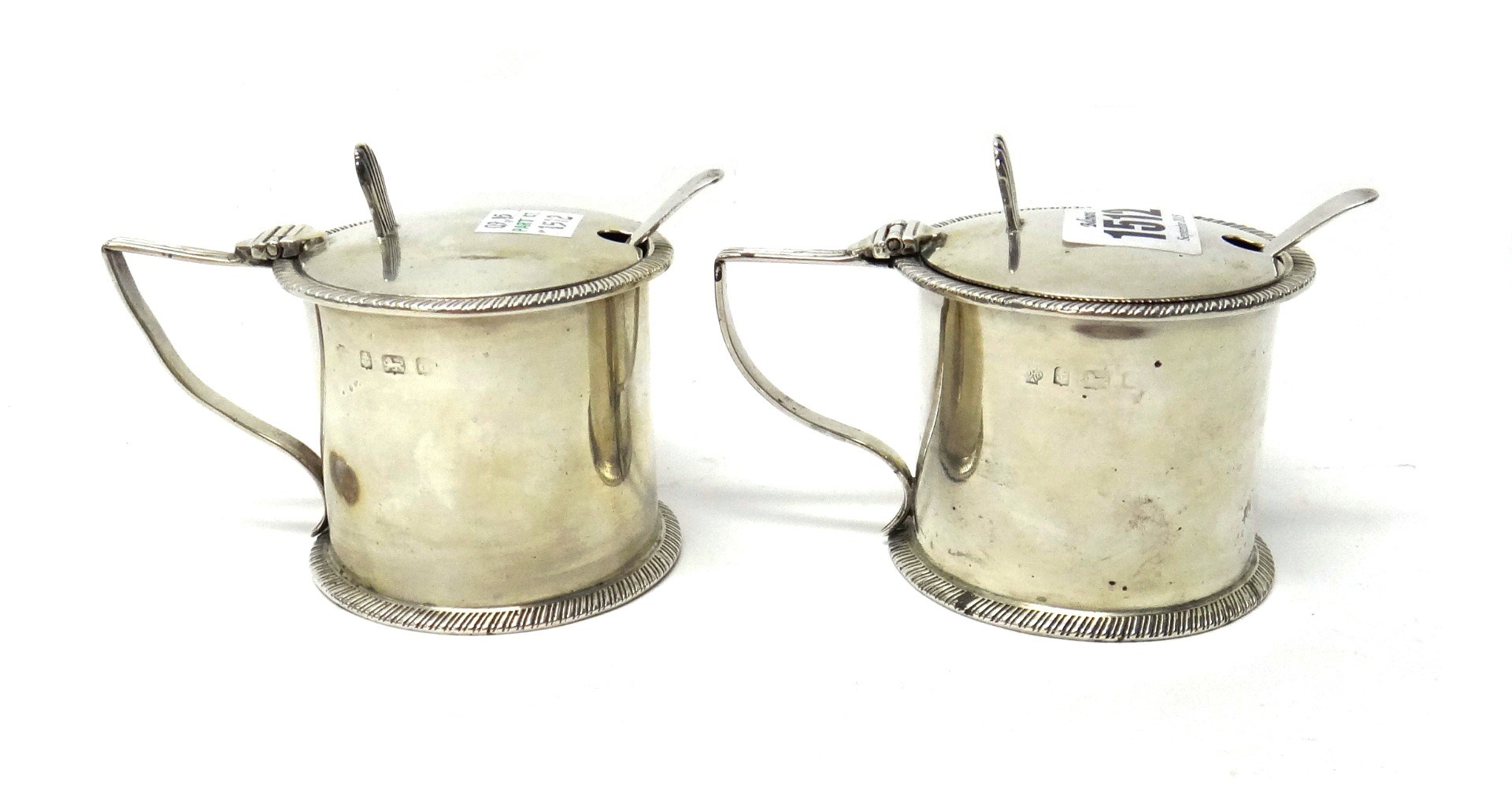 Appraisal: A pair of silver mustard pots each of cylindrical form